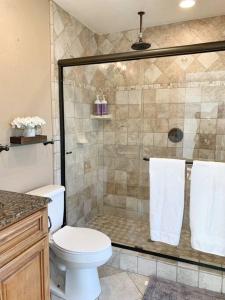 a bathroom with a shower and a white toilet at Hot Tub . Near Freeway . Quick 2 Theme Parks/Beach in Huntington Beach