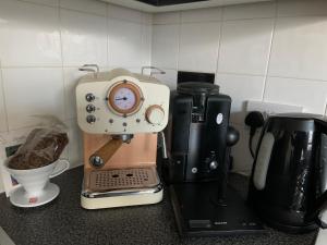 a coffee maker sitting on top of a counter at Immaculate cosy flat next to Holyrood Park! in Edinburgh