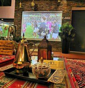 a tray with a tea pot and a kettle on a table at G R A N D C H A L E T in Salalah