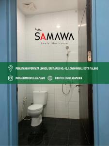 a bathroom with a white toilet in a room at Villa Samawa in Malang +9 photos