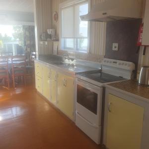 a kitchen with a stove and a sink in it at Daydream house, Sunrise, sunset views across lake in Rotorua