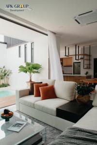 a living room with a white couch and a table at Onyx Pool Villa in Chiang Mai