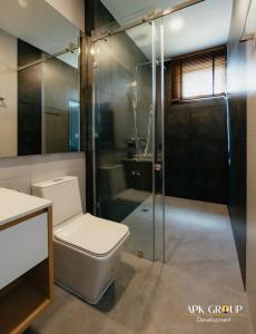 a bathroom with a toilet and a shower at Onyx Pool Villa in Chiang Mai