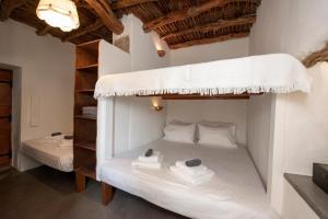 a bedroom with two bunk beds in a room at Giourgas Cottage Milos Island in Ralaki