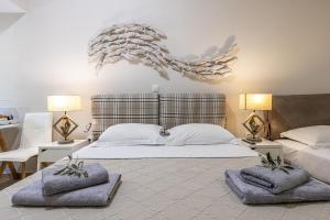 a bedroom with a large bed with two pillows at Comfort Stay Airport Studios - FREE shuttle from the Athens airport in Spata