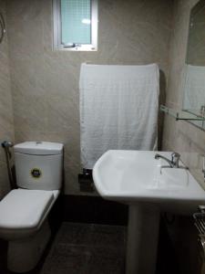 a bathroom with a white toilet and a sink at River Valley in Weligama +10 photos