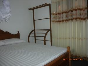 a bedroom with a bed and a ladder next to a window at River Valley in Weligama