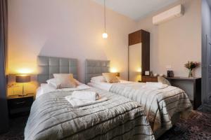 a hotel room with two beds with towels on them at Aparthotel Cracovia Residence in Krakow