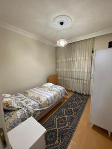 two beds in a room with a rug at KK4 İMZAOĞLU 6 in Istanbul