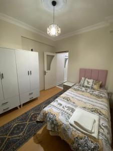 um quarto com uma cama e um armário branco em KK4 İMZAOĞLU 6 em Istambul