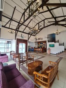 a large living room with wooden tables and chairs at DSH Batu Burok Beach Resort in Kuala Terengganu