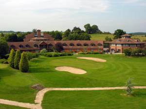 an aerial view of a golf course with a building at Abbey Hotel Golf & Spa in Redditch