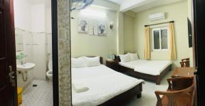 Postel nebo postele na pokoji v ubytování Thuy Van Hotel