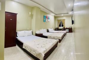 Postel nebo postele na pokoji v ubytování Thuy Van Hotel + 9 fotografií