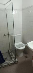 a bathroom with a toilet and a glass shower at Oinoi Hotel in Agios Kirykos