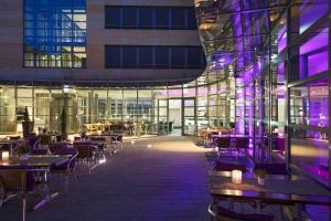 a restaurant with tables and chairs in a building at Four Points by Sheraton Munich Messe in Munich