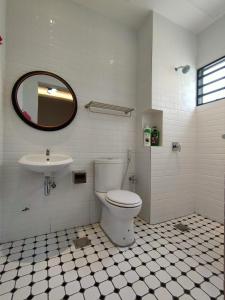 La salle de bains est pourvue de toilettes et d'un lavabo. dans l'établissement Cameron Lovely Cottage 3 Rooms, à Tanah Rata