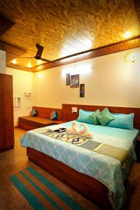 a bedroom with a large bed in a room at Creek Forest - Riverside Boutique Resort in Rishīkesh