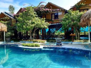 a swimming pool in front of a house at Phong Nha Bolero Bungalow in Phong Nha