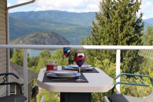 a table with two glasses of wine on a balcony at Selah Retreat Guesthouse B&B in Sorrento