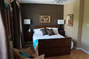 a bedroom with a bed with pillows on it at Selah Retreat Guesthouse B&B in Sorrento