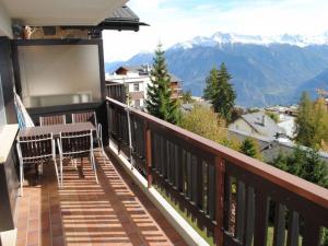 a balcony with benches and a view of mountains at Residence Mandarin in Crans-Montana