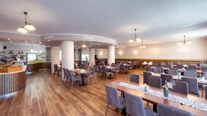 a restaurant with tables and chairs in a room at Wellness Hotel Thermal in Štúrovo