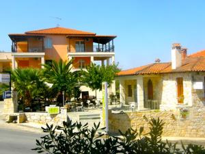 a large house with a courtyard in front of it at Afytos Sivilla in Afitos