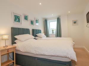 a bedroom with a bed and a window at Fistral Retreat in Newquay