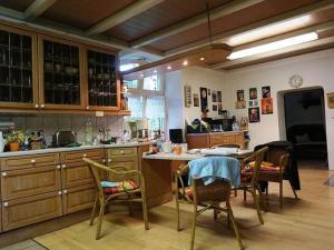 a kitchen with a table and chairs in a room at Spacious Apartment in Lalendorf with Barbecue in Krassow