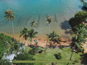 an aerial view of a beach with palm trees at Resolution Resort in Ko Chang