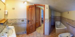 a bathroom with a sink and a toilet and a tub at Albergo Diffuso Borgo Montemaggiore in Montemaggiore al Metauro +104 photos