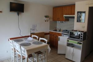 a small kitchen with a table and a microwave at Appartement Lac de Payolle in Campan