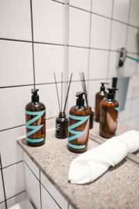 a group of bottles sitting on a counter in a bathroom at Barsebäck Resort Hotell in Löddeköpinge