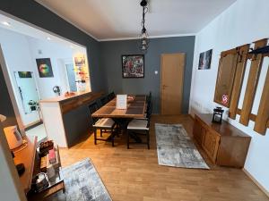 a living room with a table and a dining room at Holiday Home GC30 in Cristian