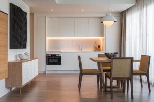 a kitchen and dining room with a table and chairs at Hyatt Regency Lisbon in Lisbon