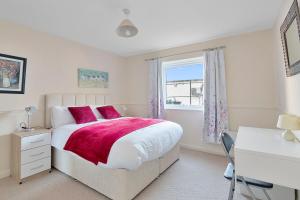 a bedroom with a bed and a desk and a window at Elegance Graceland in Gillingham