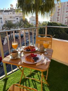 a table with food and drinks on a balcony at Mediterránean & Sun in Minerva, Benalmádena in Benalmádena