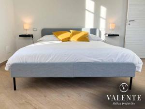 una camera da letto con un grande letto con cuscini gialli di Villa Valente - Apartments a Capannori
