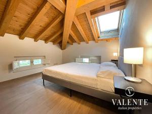 a bedroom with a large bed in a room with wooden ceilings at Villa Valente - Apartments in Capannori
