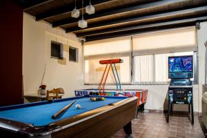 a billiard room with a pool table and a tv at Ilyssion Holidays Hotel in Ialyssos +22 photos