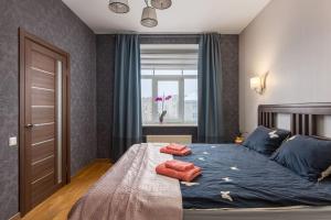 a bedroom with a bed with two pillows on it at Lovely 2-bdrm condo ideal for couples and family with children, free parking on premises in Rīga