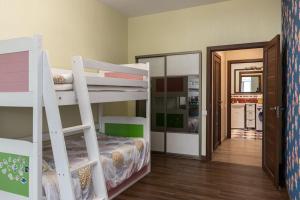 a room with two bunk beds and a hallway at Lovely 2-bdrm condo ideal for couples and family with children, free parking on premises in Riga