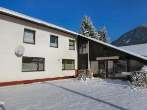 a building with snow in front of it at Haus Tapestry in Nötsch