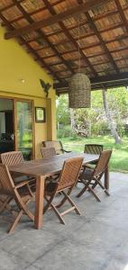a wooden table and chairs on a patio at Ocean Cottage in Kalametiya