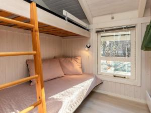 a bunk bed in a tiny house with a window at Holiday home Hals CXLI in Hals