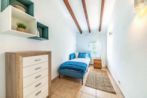 a bedroom with a bed and a dresser in a room at Villa Monsy 1 in El Port +17 photos