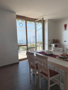 a kitchen with a table and chairs with a view of the ocean at B&B SALERNO IN in Salerno