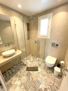 a bathroom with a shower and a toilet and a sink at Lefteris in Mikonos