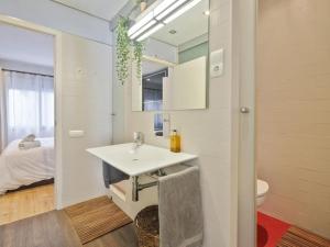a bathroom with a sink and a bed in a room at BCN: ¡Exclusivos y cerca del Camp Nou! in El Arrabal